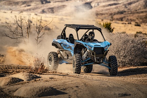 Three-quarter front angle of a person riding a sport side x side off-road. opens in a new window