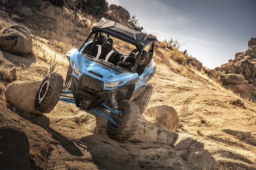 Front angle of a person riding a side x side off-road. opens in a new window