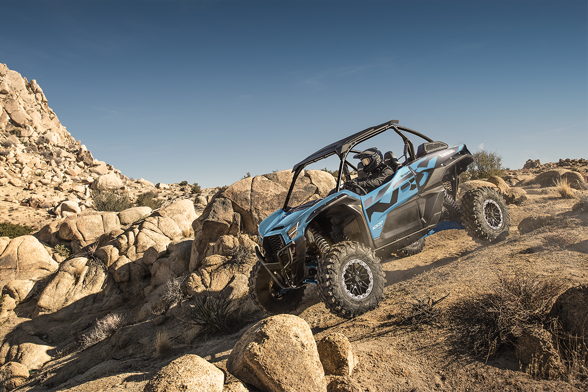 Side angle of a person riding a side x side off-road.