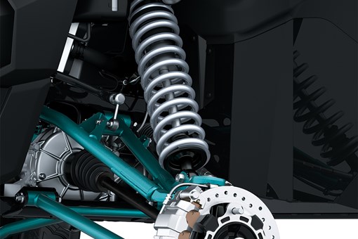 Close-up view of the front suspension and brake assembly of a side x side staged in a white studio background. opens in a new window