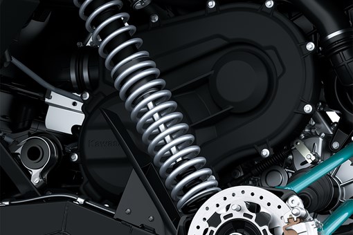 Close-up view of the front suspension and disc brake system of a side x side staged in a white studio background. opens in a new window