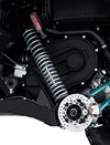 Close-up view of the front suspension and disc brake system of a side x side staged in a white studio background.