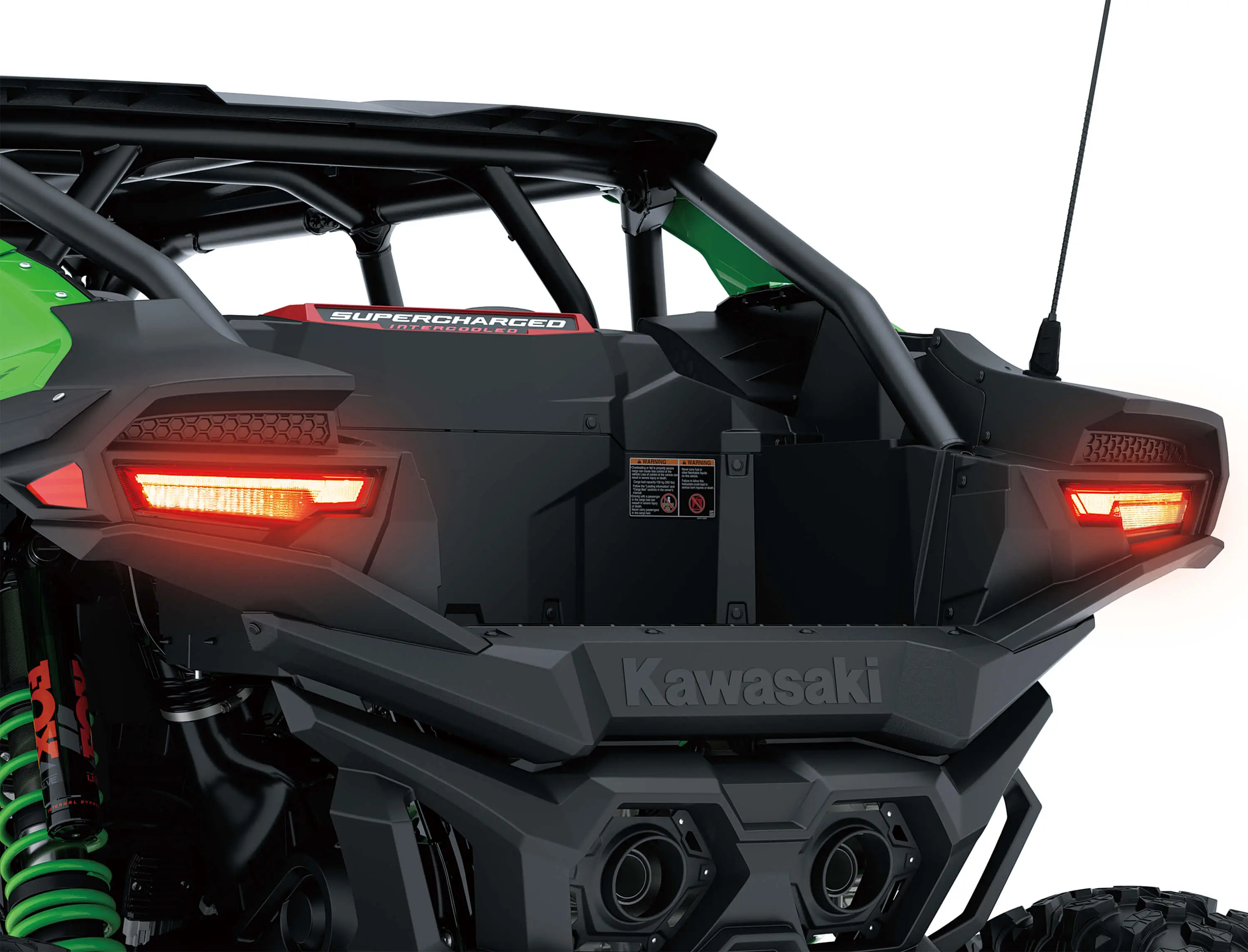 Close-up of a side x side rear with lights on in a white studio background.