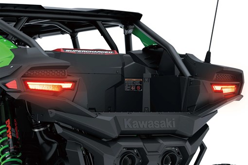 Close-up of a side x side rear with lights on in a white studio background. opens in a new window