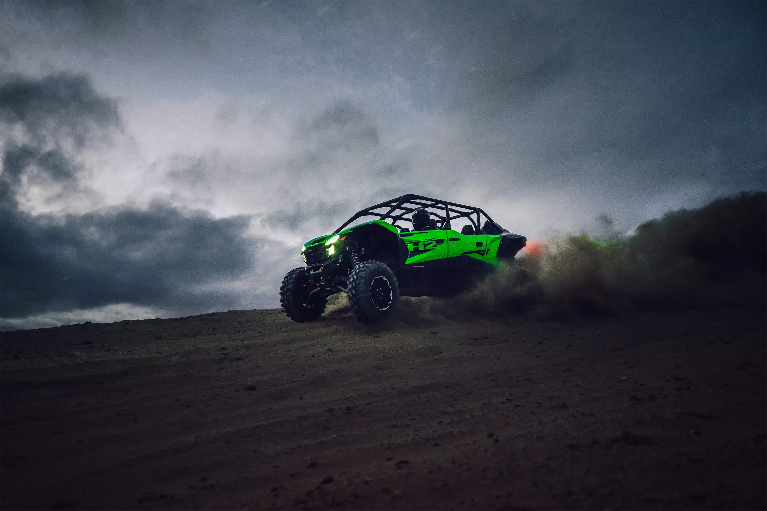 Three-quarter front angle of a person driving a side x side off-road.