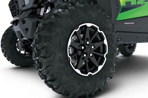 Close-up of wheels of a side x side in a white studio background. opens in a new window