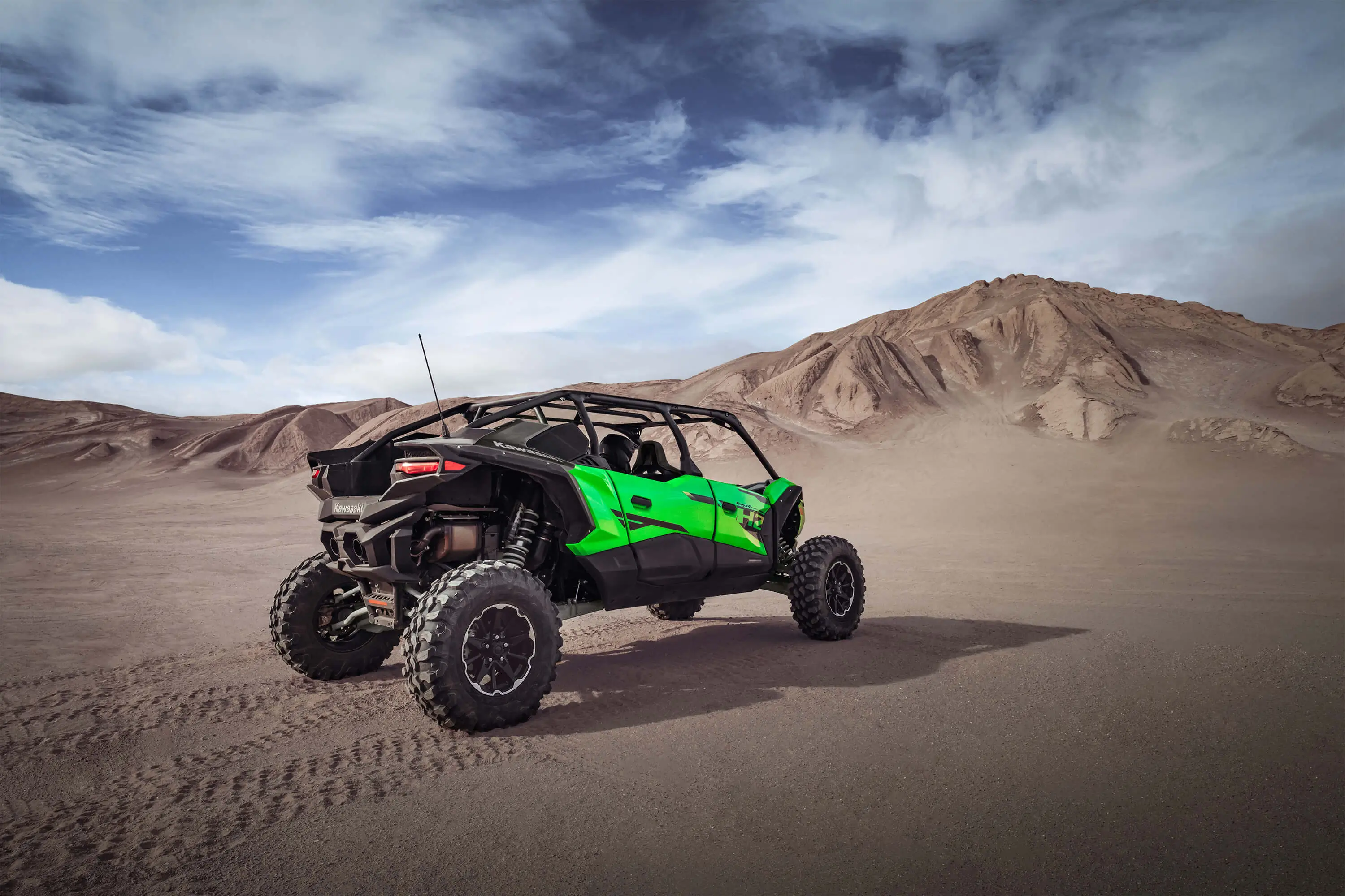 Three-quarter rear angle of a person driving a side x side off-road.