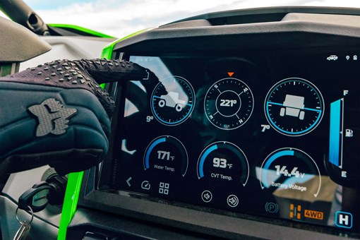 POV of infotainment screen of a side x side with drivers hand in view. opens in a new window