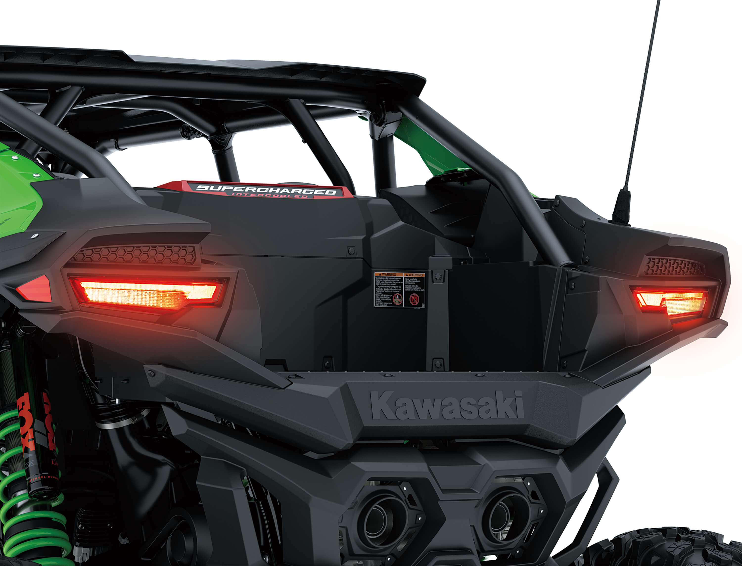 Close-up of a side x side rear with lights on in a white studio background.
