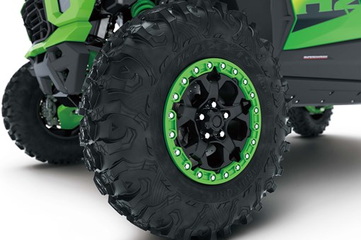 Close-up of wheels of a side x side in a white studio background. opens in a new window