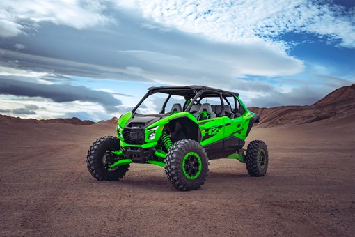 Three-quarter front angle of a side x side parked off-road. opens in a new window