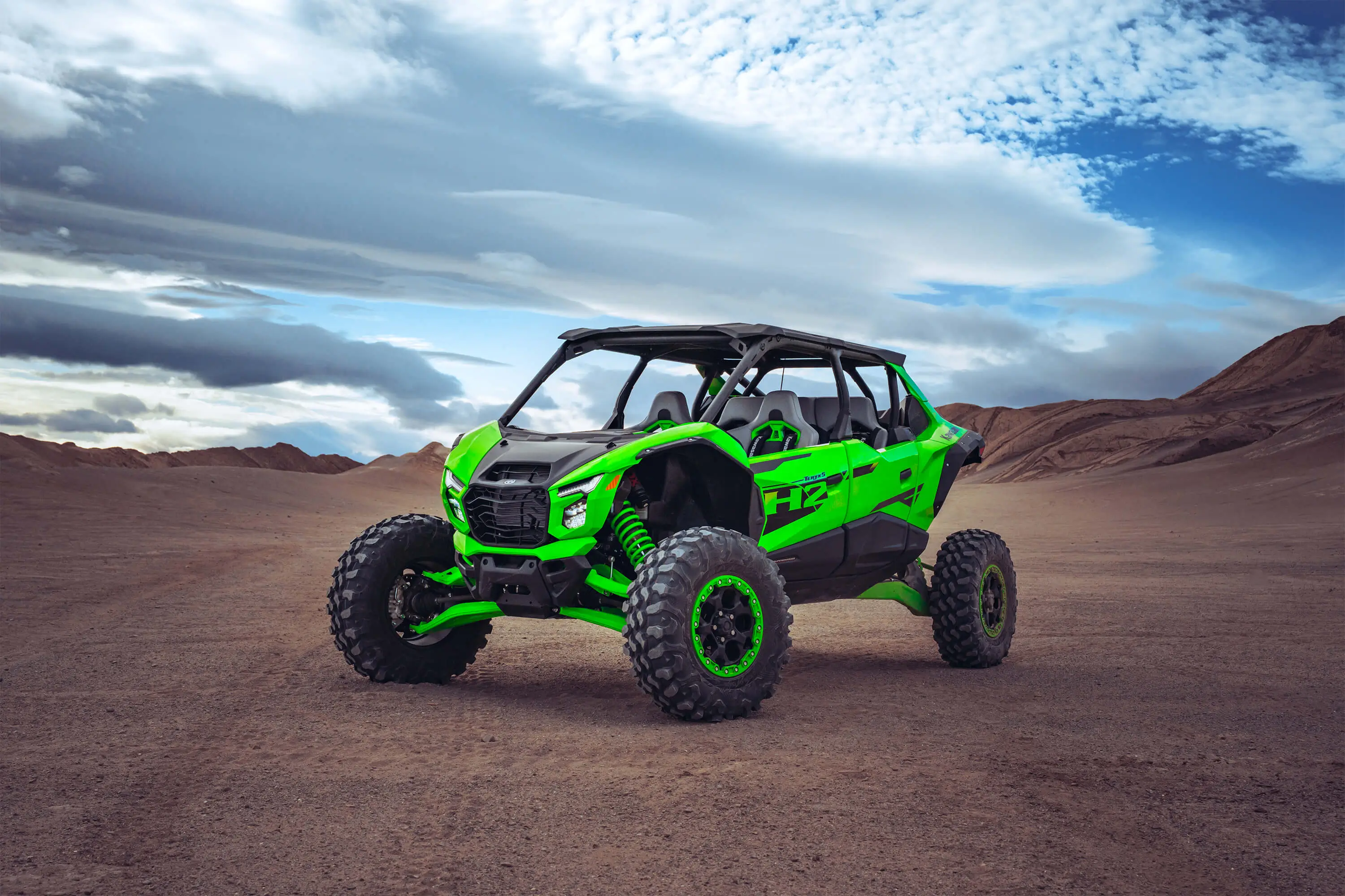 Three-quarter front angle of a side x side parked off-road.