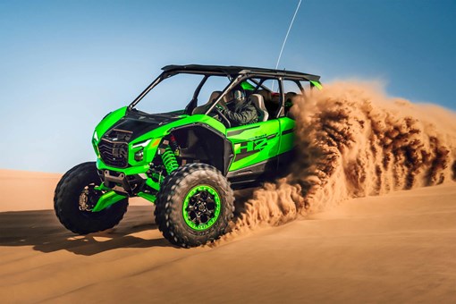 Profile angle of a person driving a side x side off-road. opens in a new window