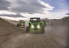 Front angle of 3 side x sides driving off-road.