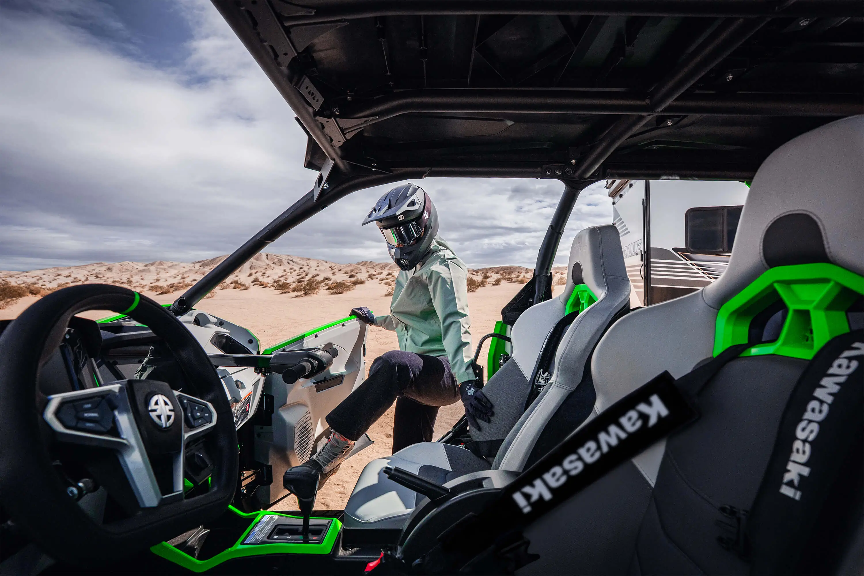 Passenger getting in a side x side off-road.