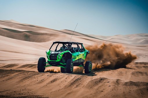 Front angle of a person driving a side x side off-road over large whoops. opens in a new window