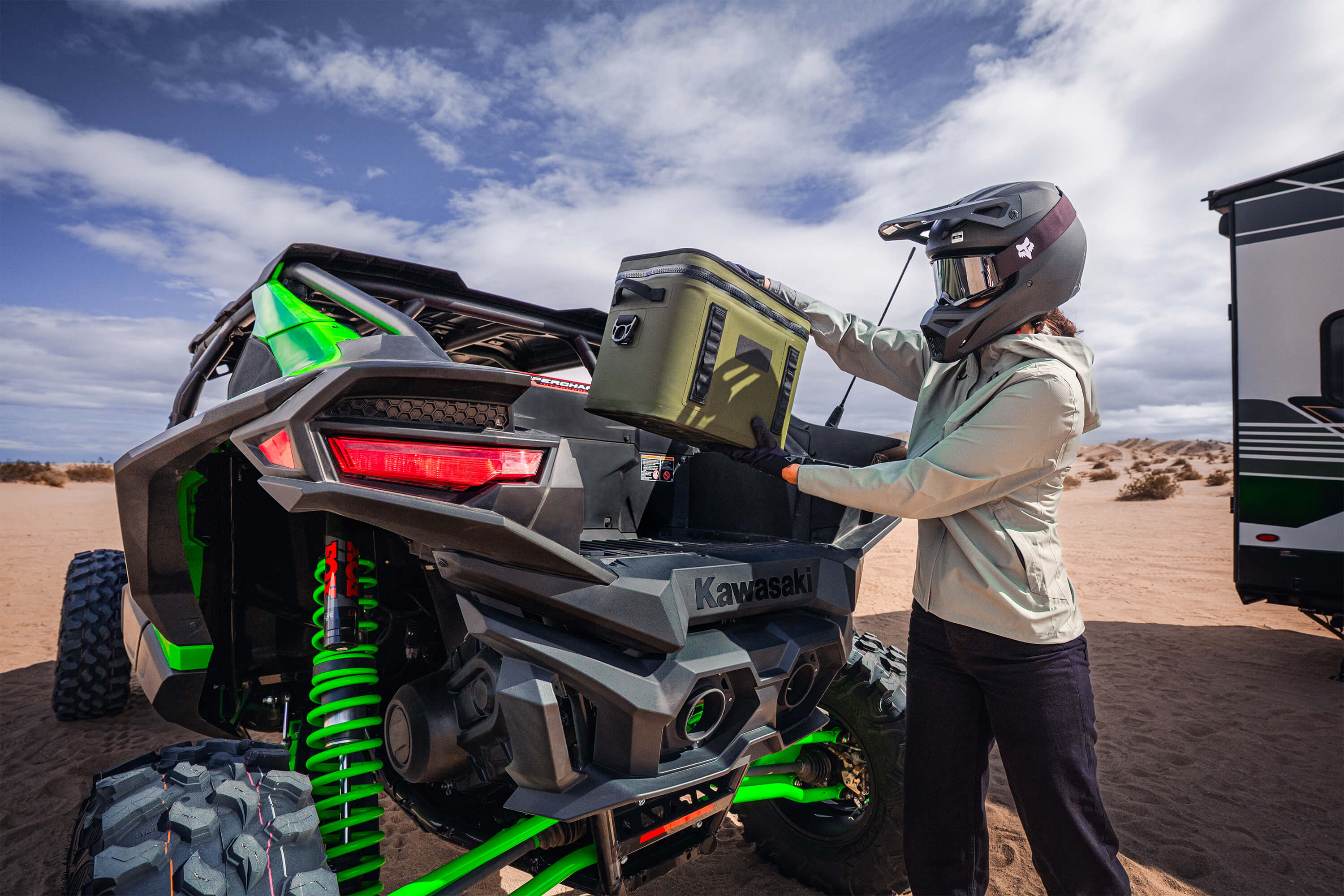 Person loading the back of a side x side off-road.