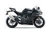 Profile angle of a black motorcycle staged in a white studio background.