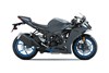 Side angle of a gray motorcycle staged in a white studio background.