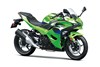 Three-quarter front angle of a green motorcycle staged in a white studio background.