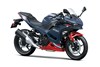 Three-quarter front angle of a blue motorcycle staged in a white studio background.