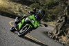 Front angle of a person riding a motorcycle on a road.