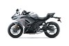 Profile angle of a silver motorcycle staged in a white studio background.