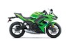 Profile angle of a green motorcycle staged in a white studio background.