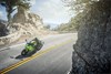 Aerial view of a person riding a motorcycle on a road.