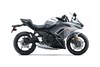 Side angle of a silver motorcycle staged in a white studio background.