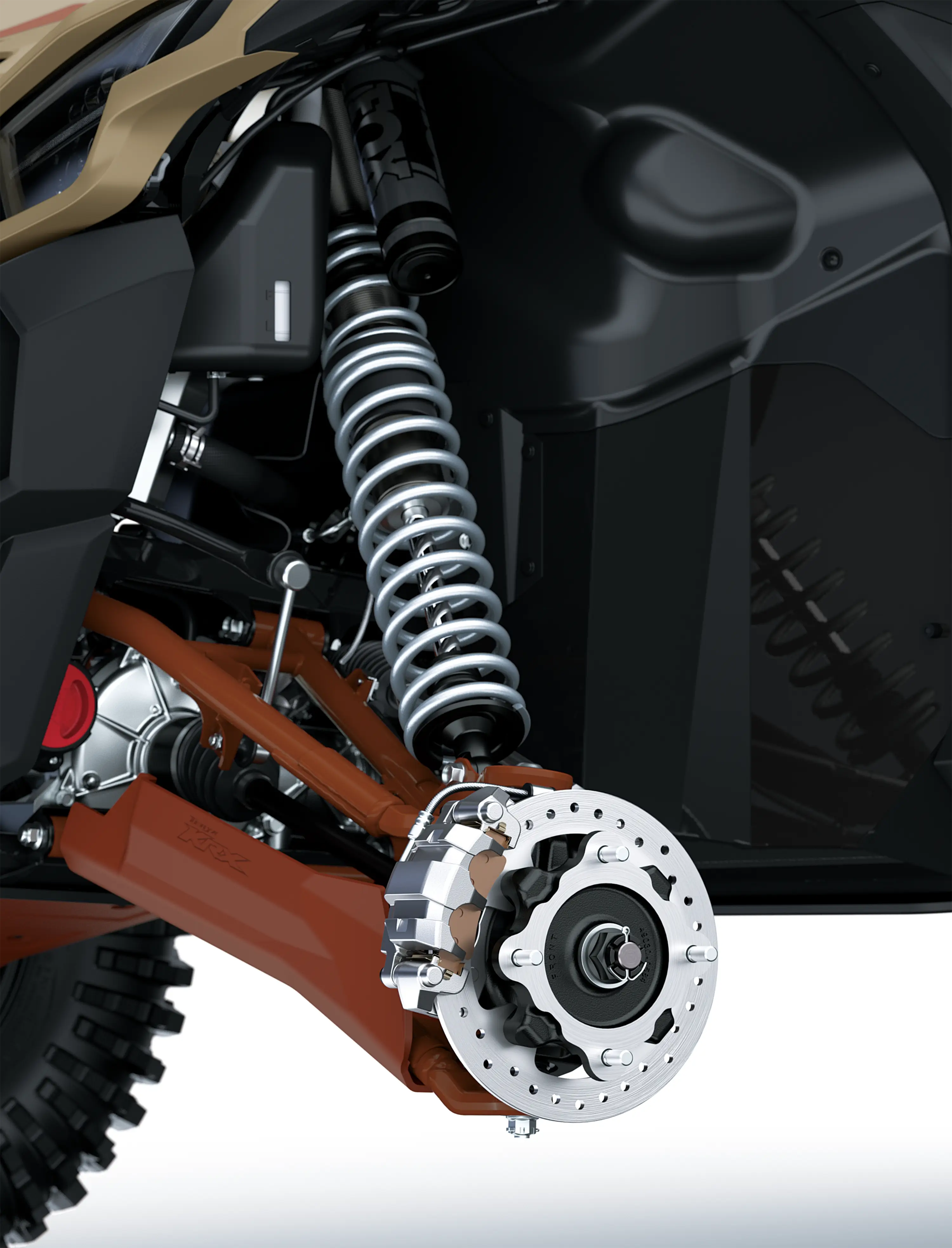 Close-up view of the suspension and brake system of a side x side staged in a white studio background.