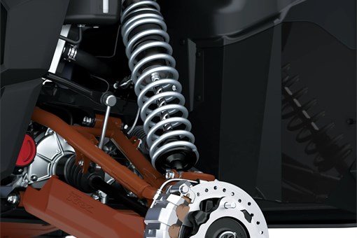 Close-up view of the suspension and brake system of a side x side staged in a white studio background. opens in a new window
