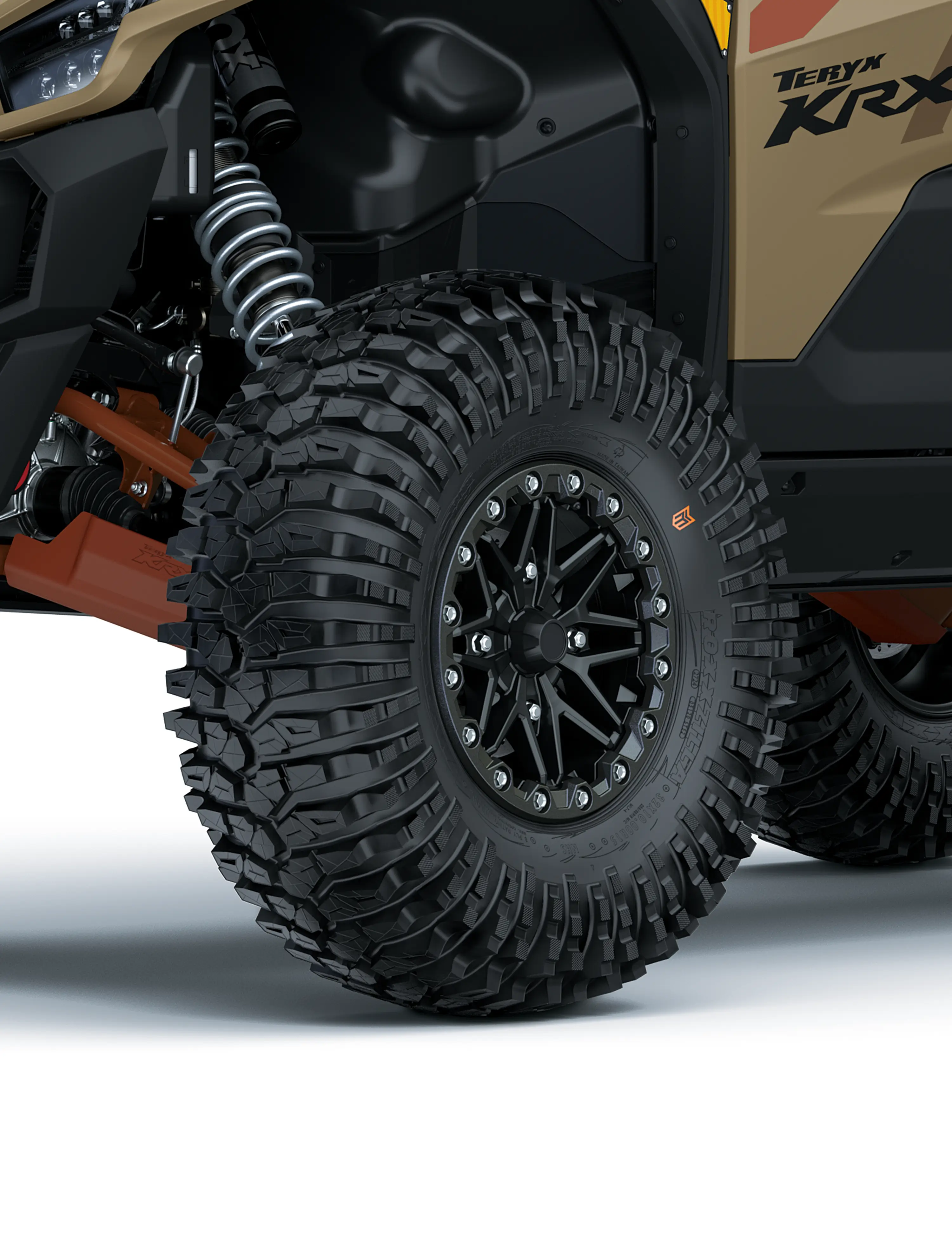 Close-up view of the front-left tire of a side x side staged in a white studio background.