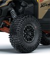 Close-up view of the front-left tire of a side x side staged in a white studio background.