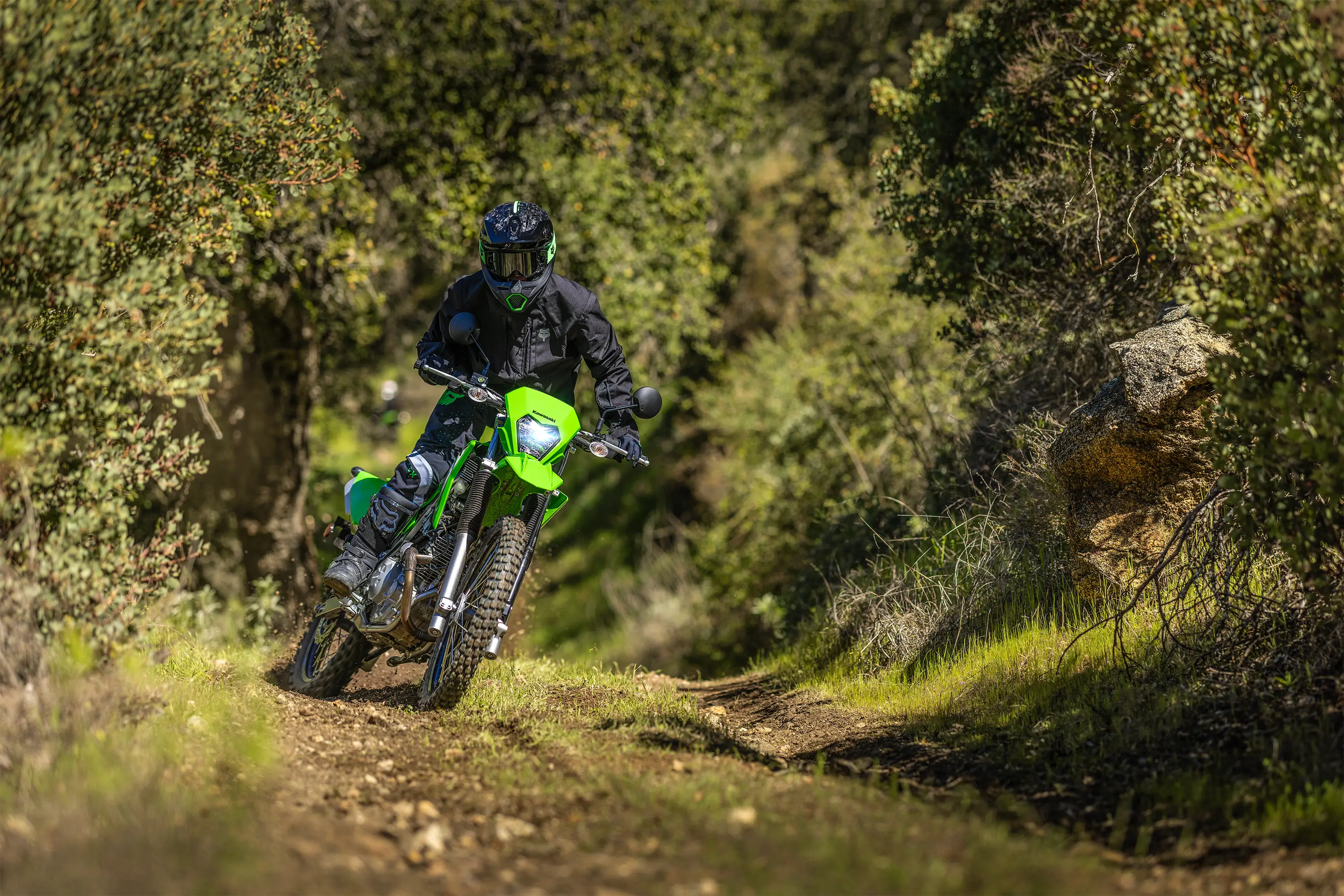 Front angle of a person riding a motorcycle off-road.