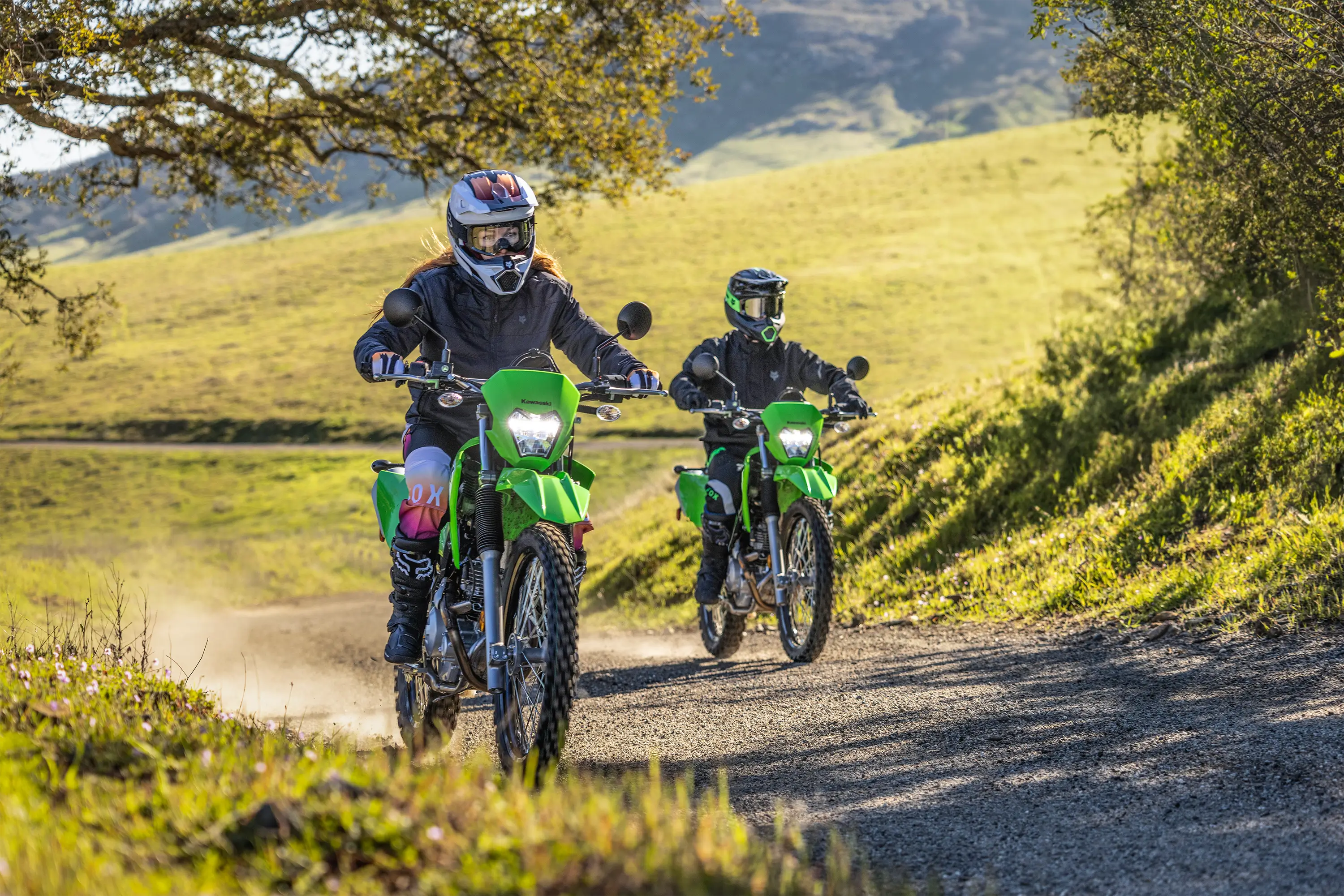 Front angle of two people riding motorcycles off-road.