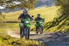 Front angle of two people riding motorcycles off-road.