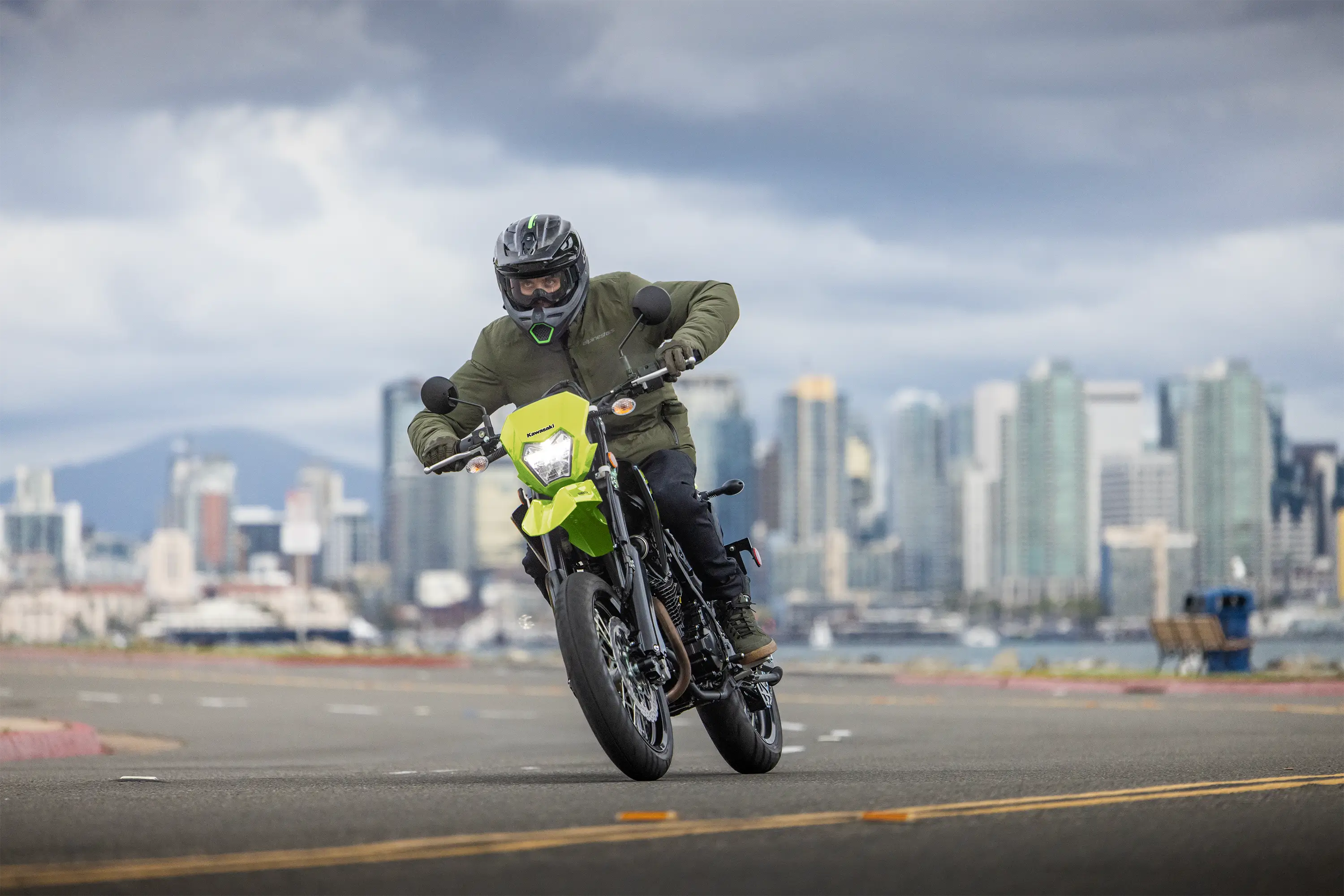 Three-quarter front angle of a person riding a motorcycle on a highway.