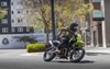 Profile angle of a person riding a motorcycle on a highway.
