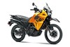 Three-quarter front angle of an orange motorcycle staged in a white studio background.