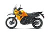 Profile angle of an orange motorcycle staged in a white studio background.