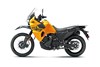 Profile angle of an orange motorcycle staged in a white studio background.