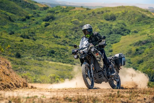 Three-quarter front angle of a person riding a motorcycle off-road. opens in a new window