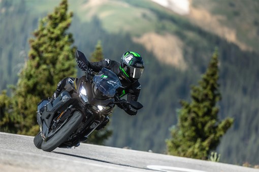 Front angle of a person riding a motorcycle on a highway. opens in a new window