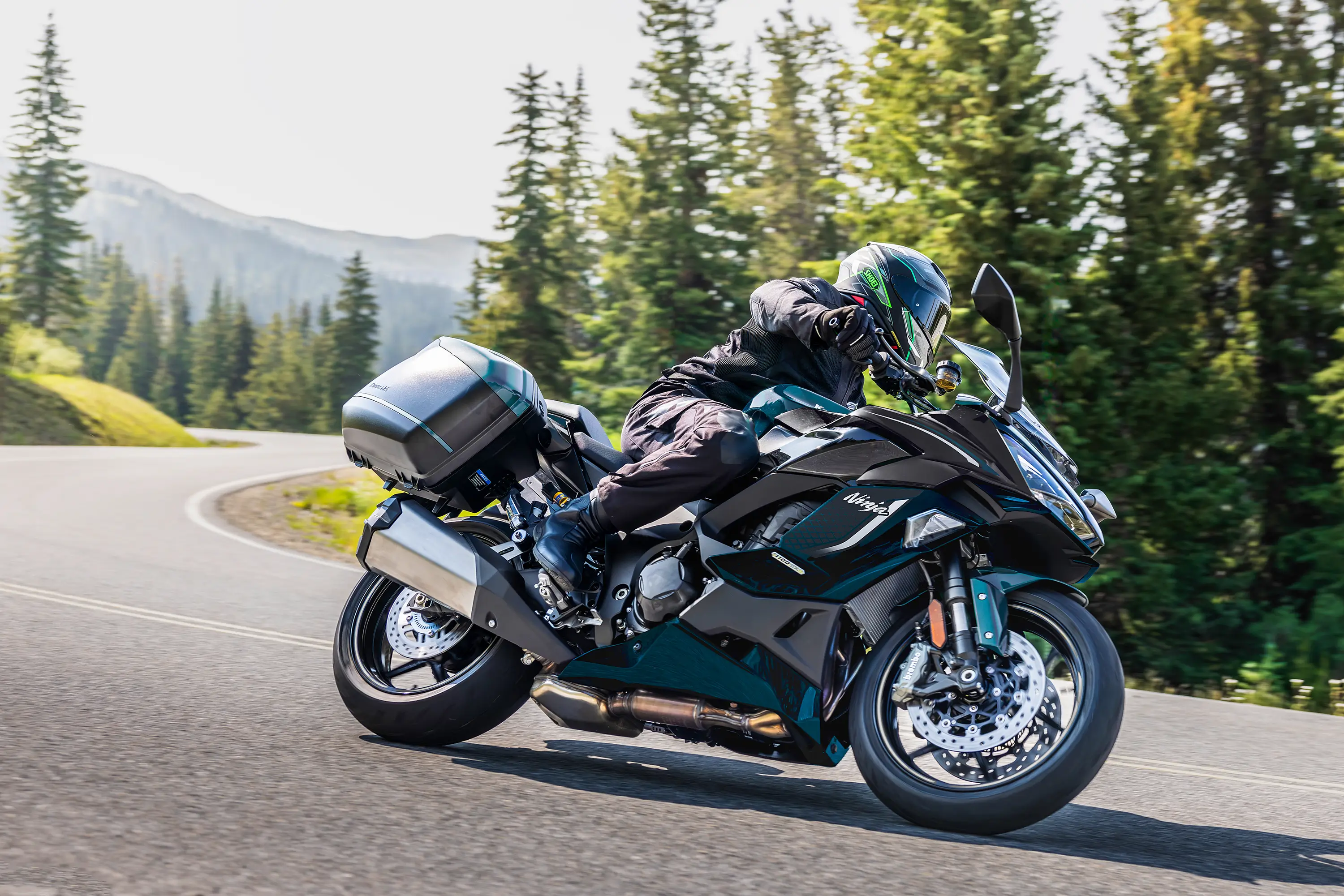 Side angle of a person riding a motorcycle on a highway.