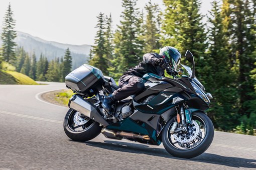 Side angle of a person riding a motorcycle on a highway. opens in a new window