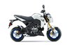 Profile angle of a white motorcycle staged in a white studio background.