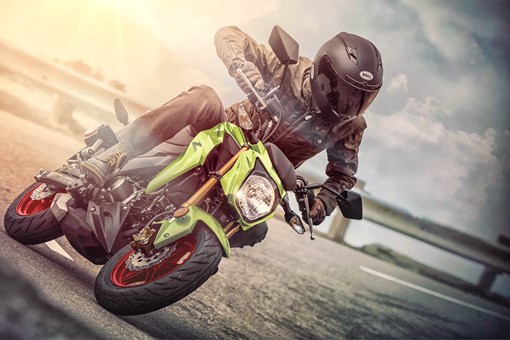 Front angle of a person riding a motorcycle on a highway. opens in a new window