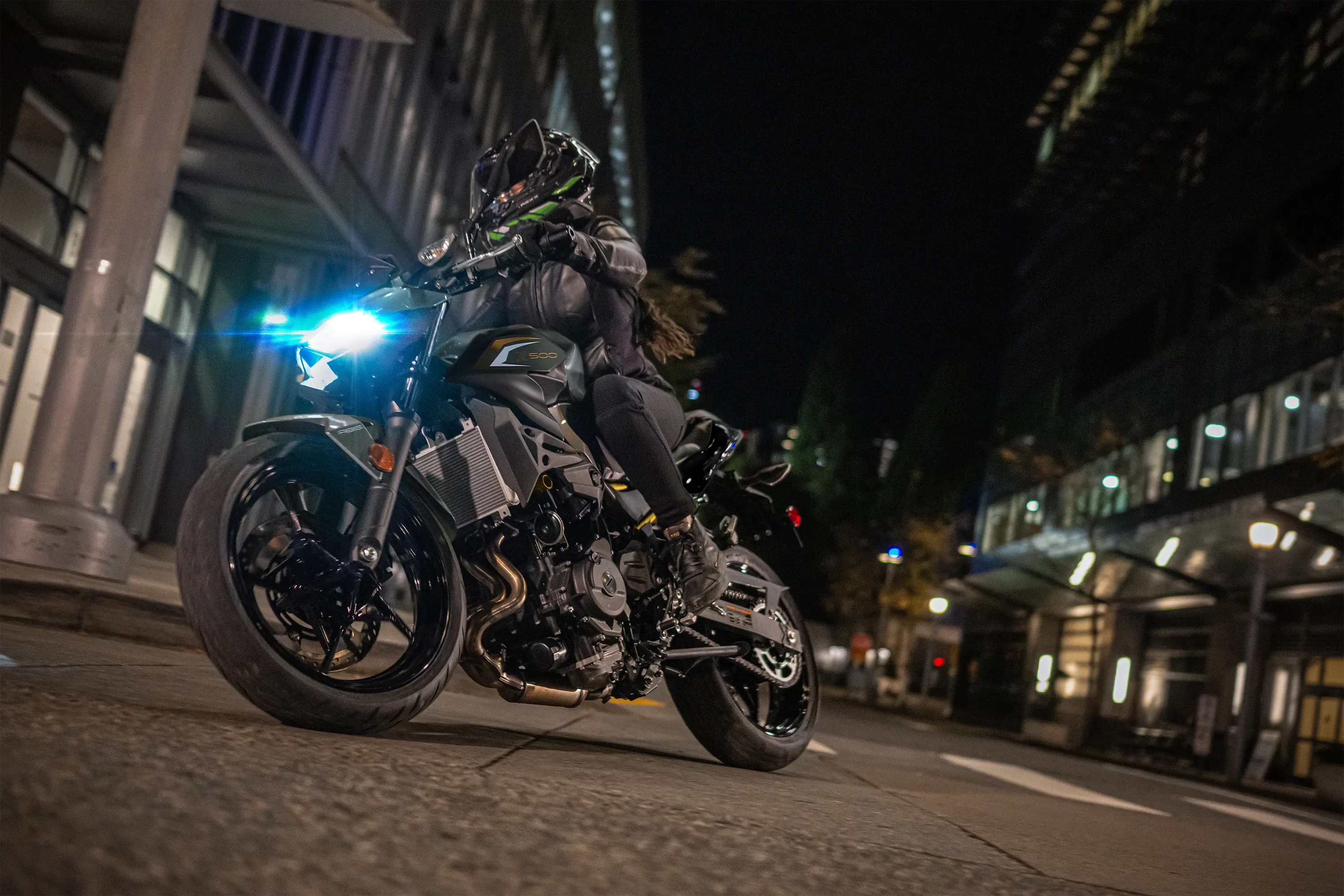 Front angle low down of a person riding a motorcycle on the street.
