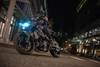 Front angle low down of a person riding a motorcycle on the street.